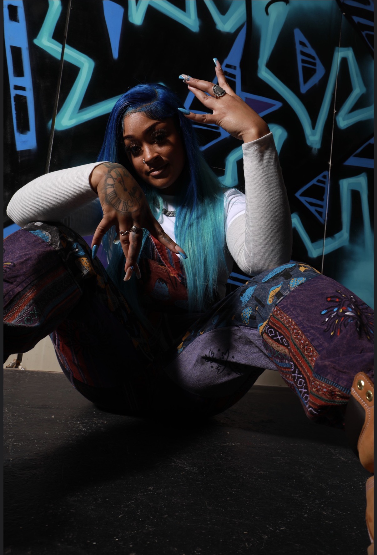 Karson Blu seated against a blue graffiti backdrop